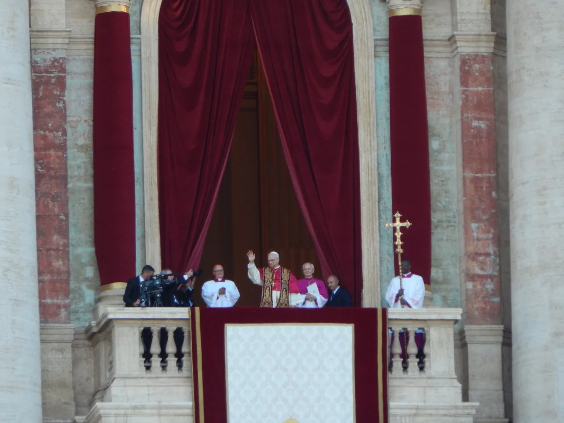 Pope Leo XIV waves at the people gathered in St. Peter's Square in his first public appearance as pope